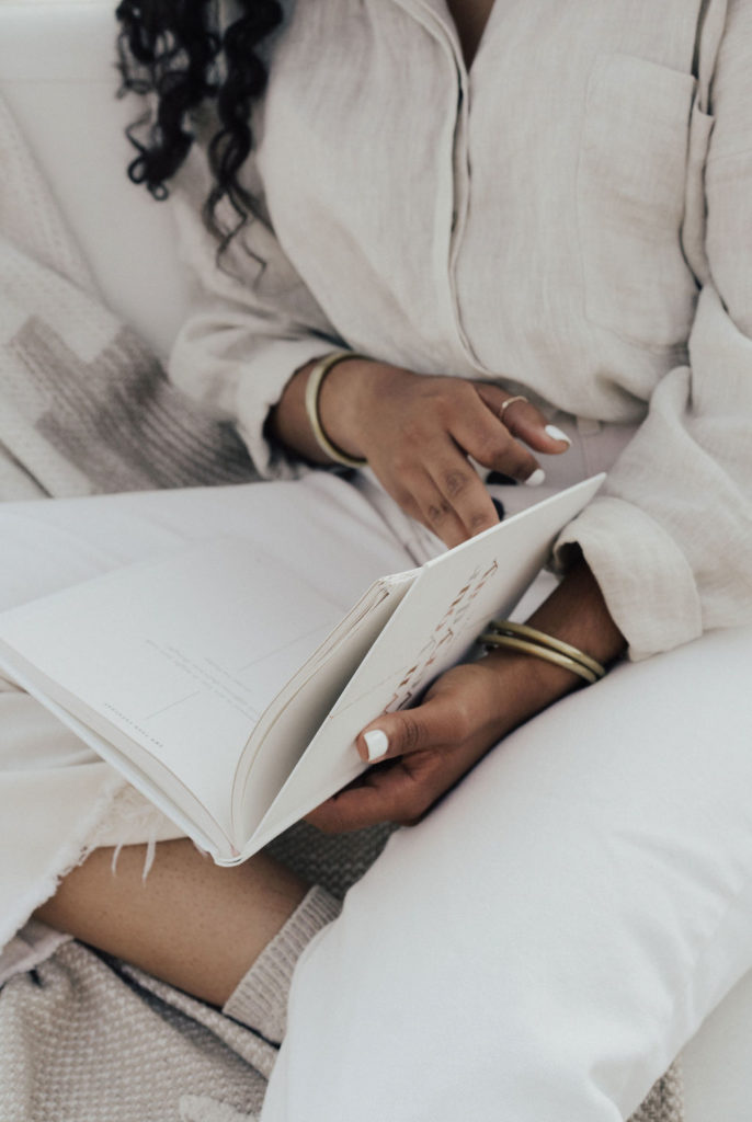 This image shows a woman holding a journal. In this episode, Jordan talks with Toni Collier about how to discover healing after pain.