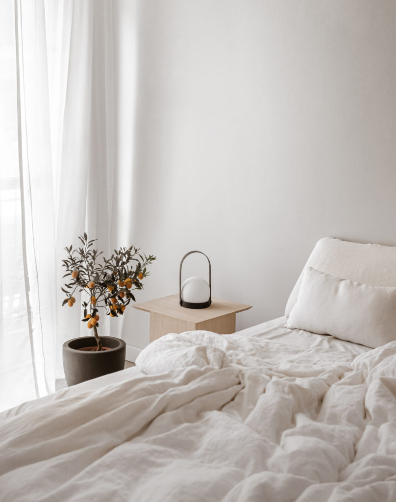 This image shows a white bedroom. In this episode, Jordan talks to Geomyra Pollard about how to manage household tasks.