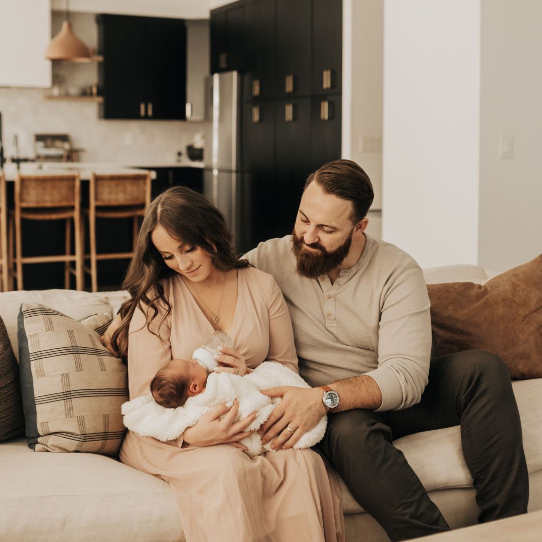 This image shows Matt and Jordan holding their newborn son. In this episode, they share their story of how they became parents.
