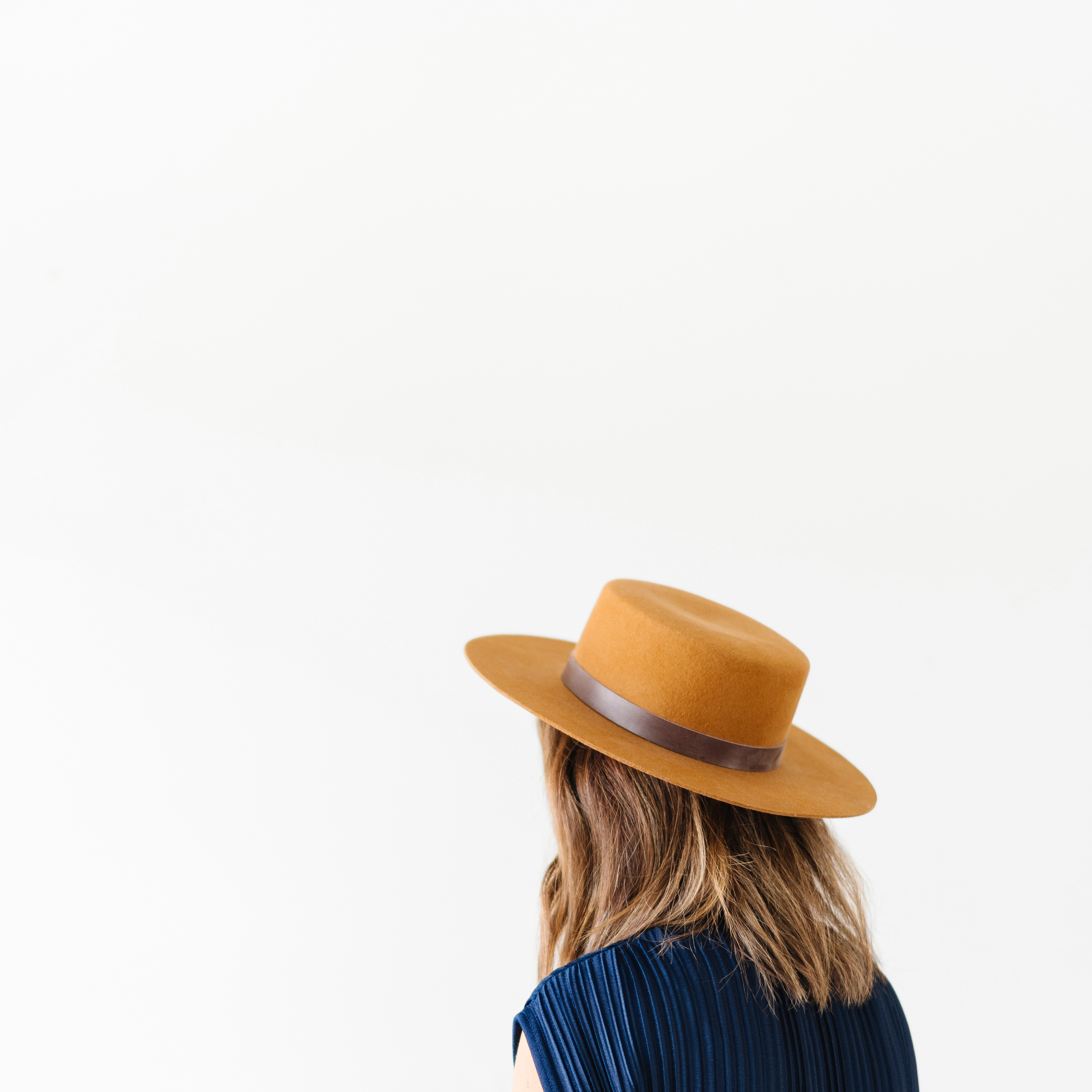 This image shoes a woman facing away from the camera, with a hat on. Michele Cushatt talks about 10 practices to build up your faith.