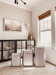 This image shows all three sizes of AirDoctor air purifiers lined up next to each other.
