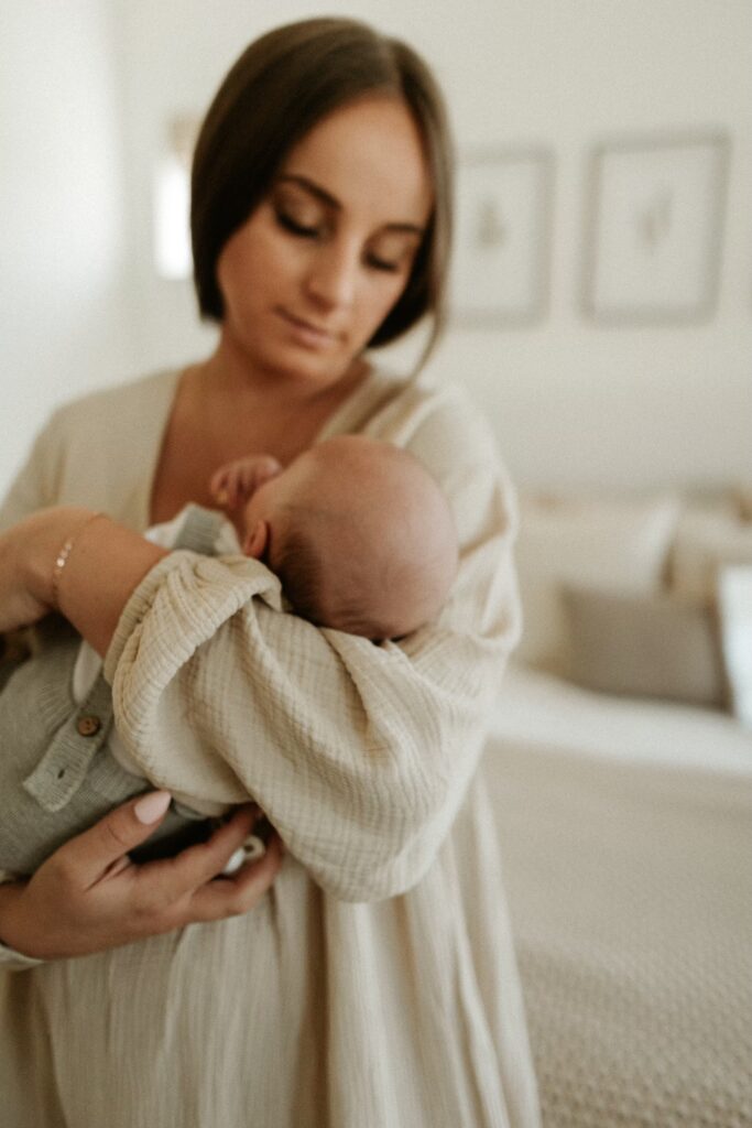 This image shows Jordan holding her newborn son. In this episode, she talks with a lactation consultant about how to navigate breastfeeding.