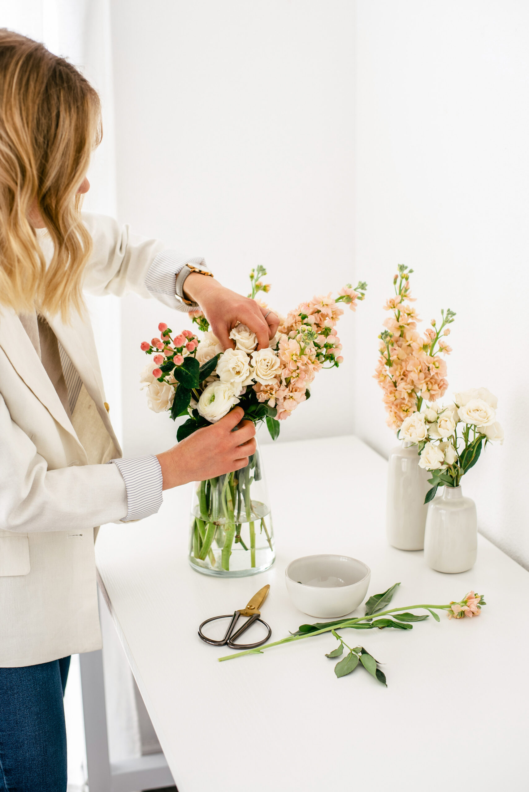 This image shows a woman arranging a bouquet of flowers. In this episode, author Grace Wabuke Klein talks about flourishing in any season of life.
