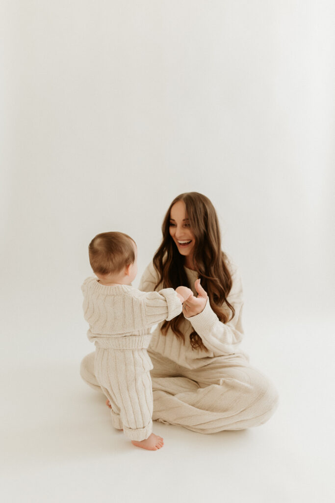 This image shows Jordan sitting on the floor and playing with her son. In this episode, Jordan talks about how to make the shift to a more holistic lifestyle.
