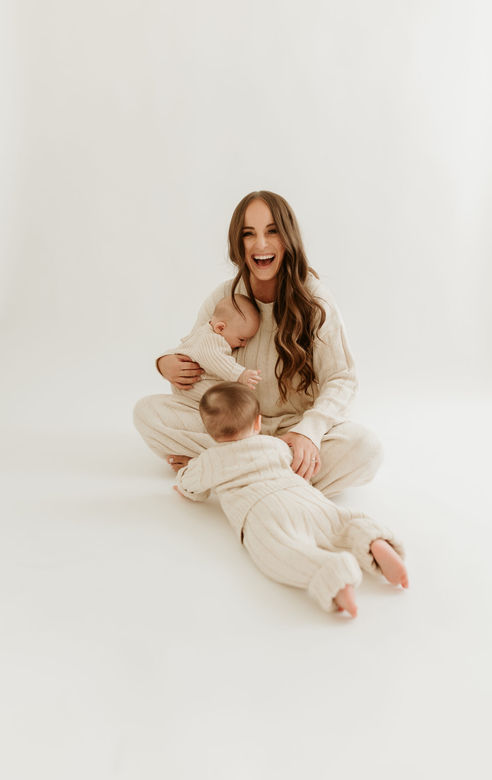 This image shows Jordan playing with her two infant sons. This episode talks about how to support your family's immune health.