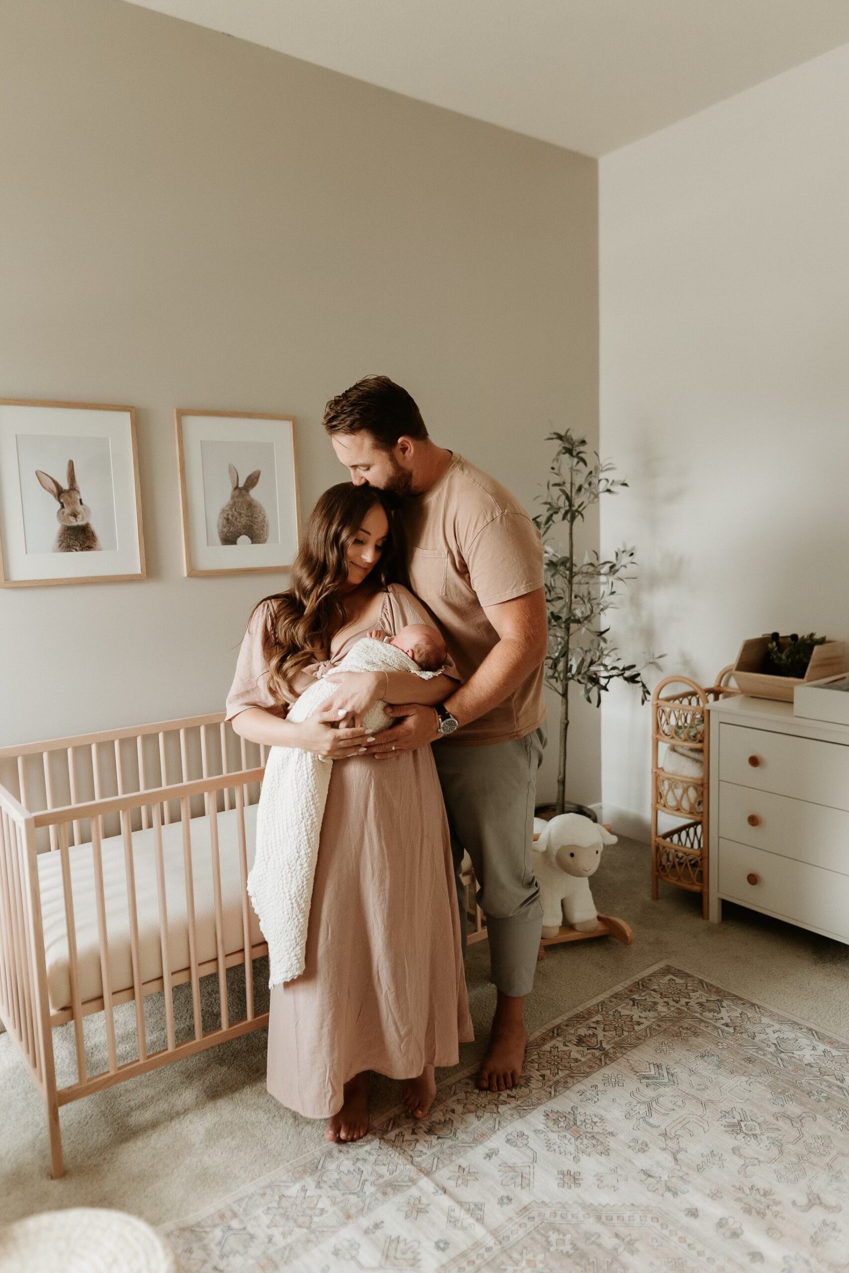 This image shows Jordan and her husband Matt holding their newborn son in his nursery. This episode talks about making informed vaccine decisions as a parent.