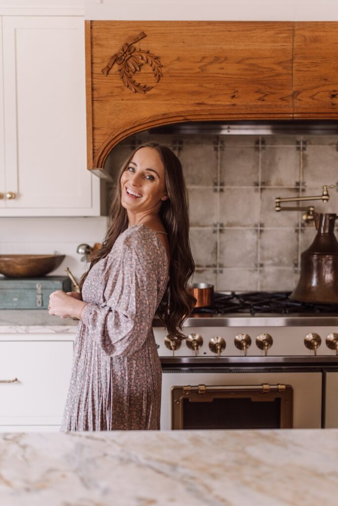 This image shows Jordan standing in a kitchen and laughing at the camera.