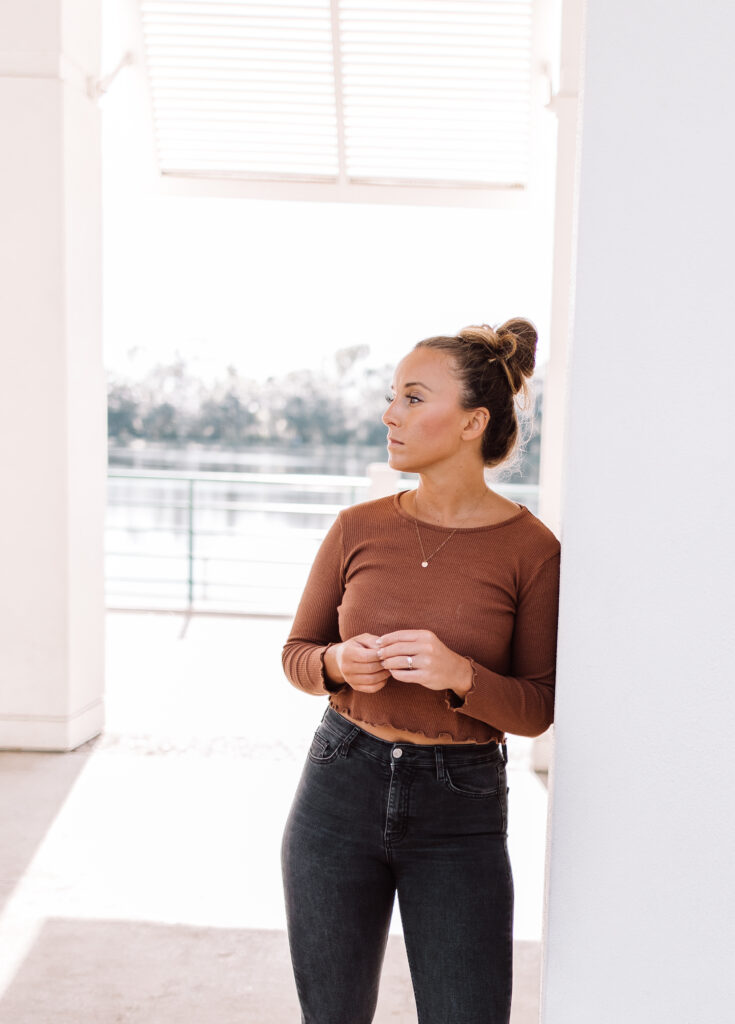 This image shows Jordan leaning against a wall while looking off to the side.